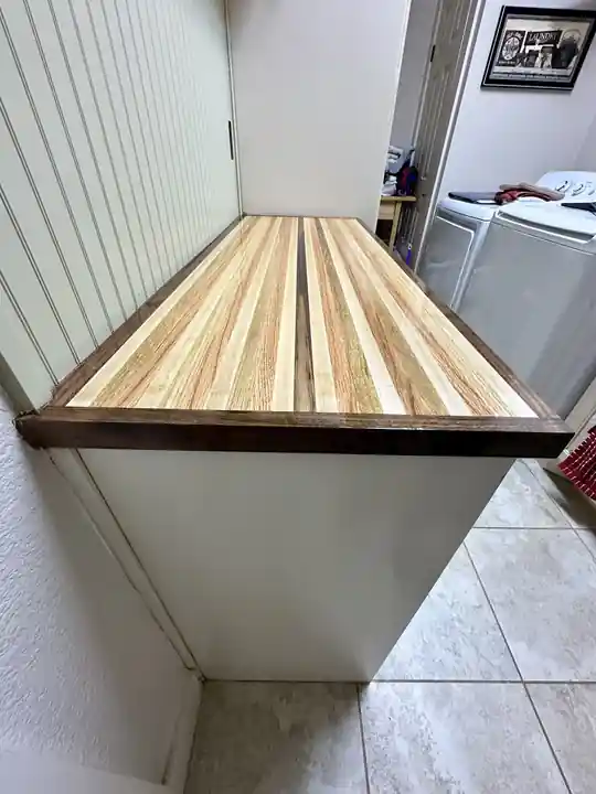 Painted laundry room built-ins with a butcher block top