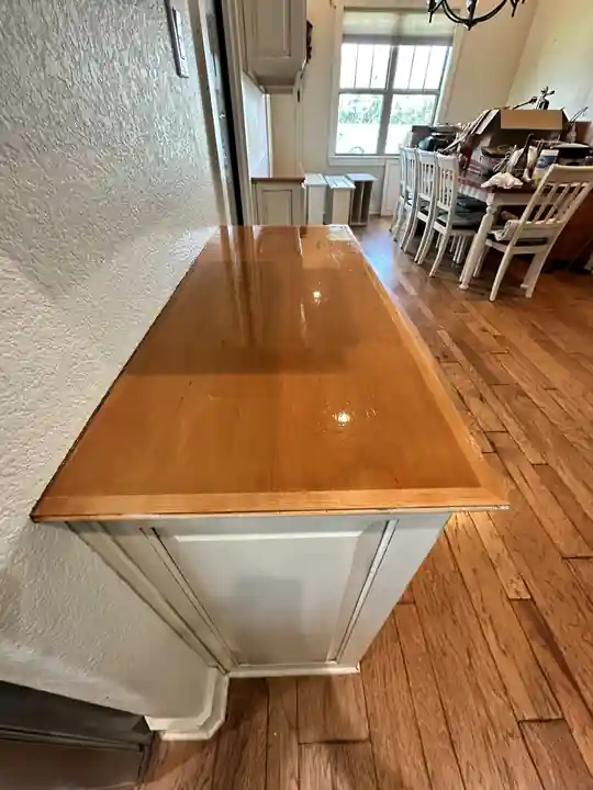 A painted kitchen island with a wood top