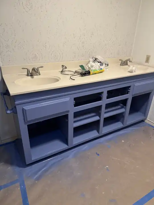 A vanity base mid-job with the floor masked