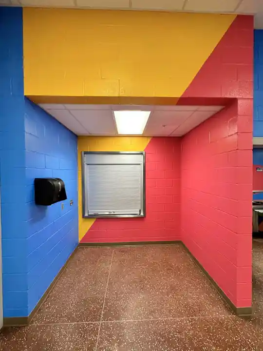 Block walls painted in bold red, yellow and blue
