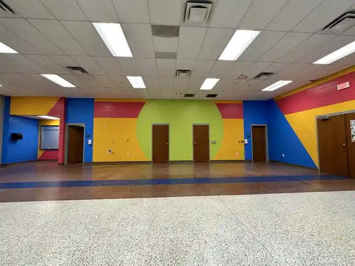 A block-wall hall painted in primary colours