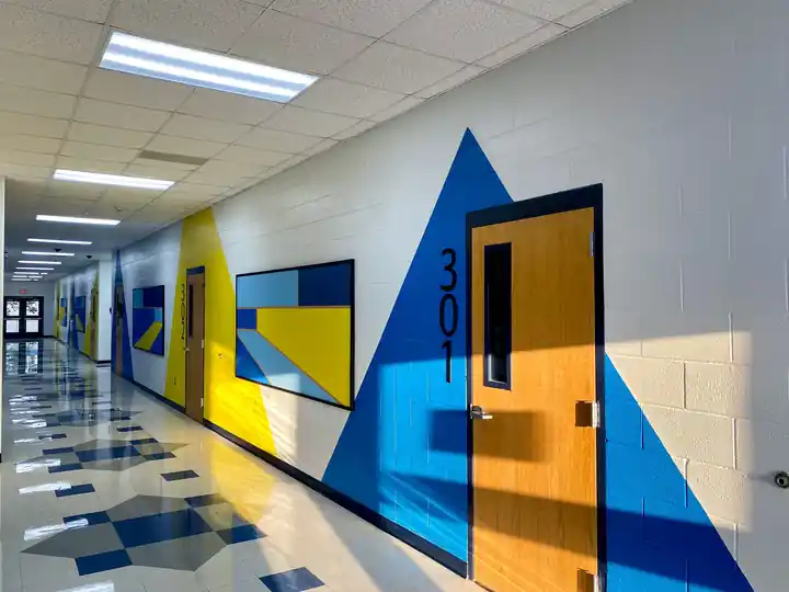 A school corridor with blue and yellow geometric walls