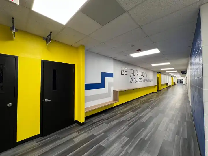 A school corridor with yellow and navy walls and lettering